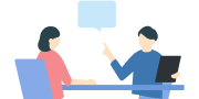 ノートパソコンを挟んで向かい合って話す2人のイラスト